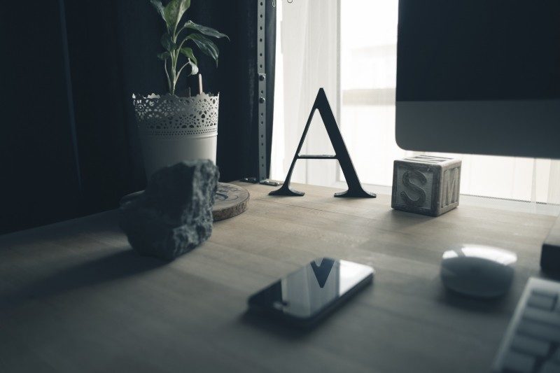 cropped-mobile-phone-computer-rock-and-potted-plant-on-table.jpg